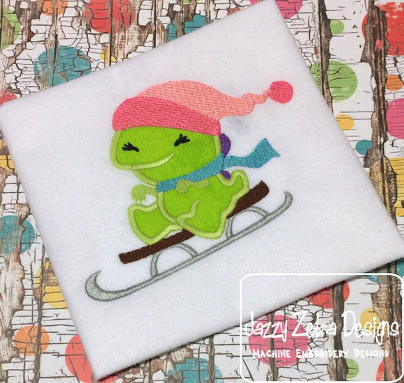 Dinosaur on sled applique machine embroidery design