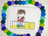 School boy sitting on ruler sketch machine embroidery design